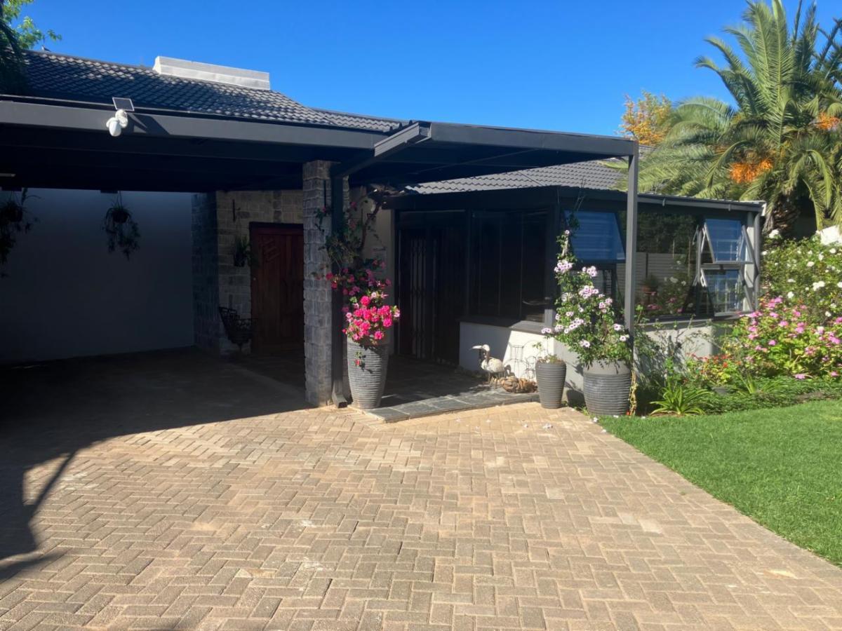 Entrance with flowers and palms